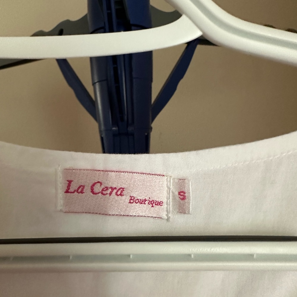 White cotton blouse with white embroidered flowers.